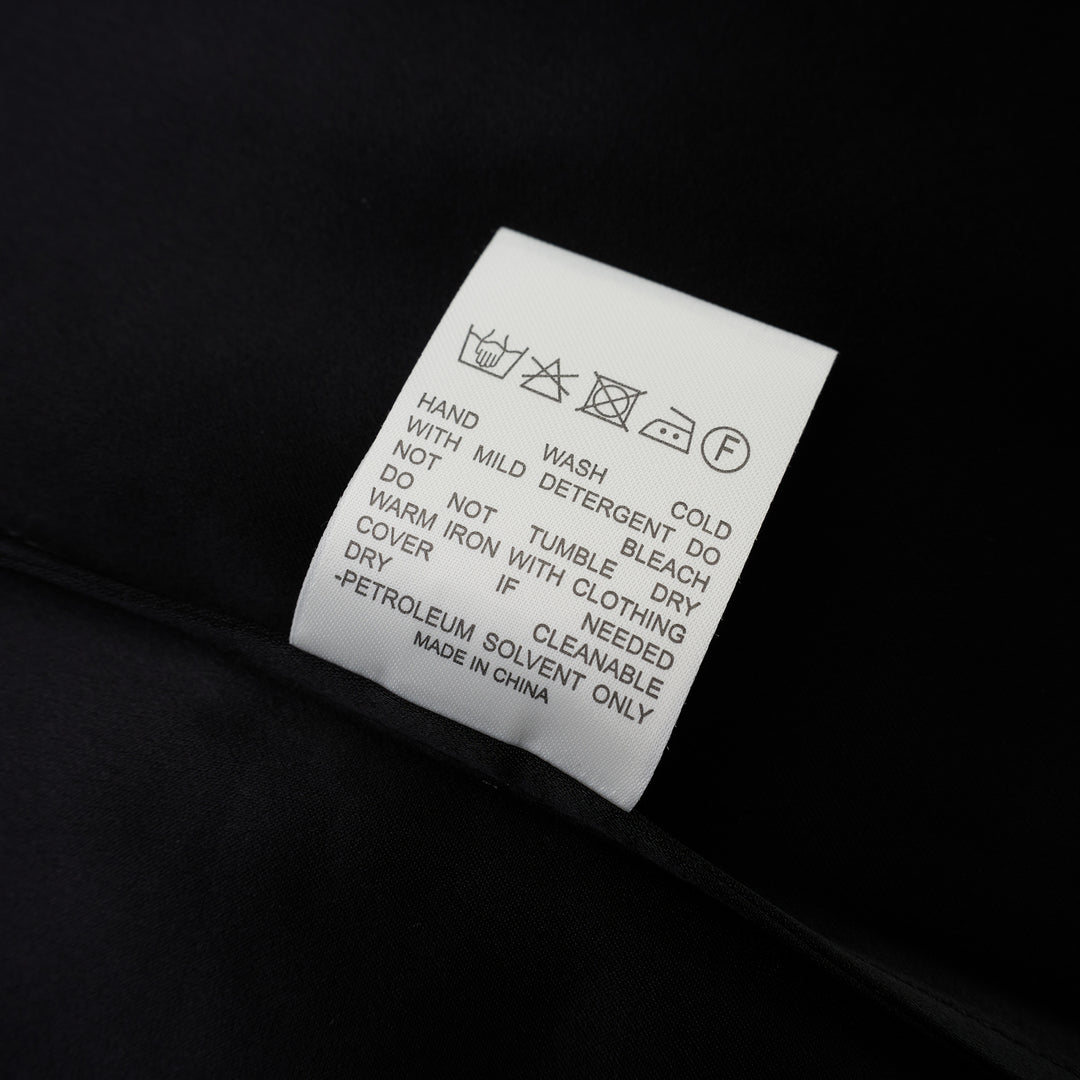 Black matte satin long-sleeve blouse with crew neckline and wide cuffs, shown flat from the front - view 4