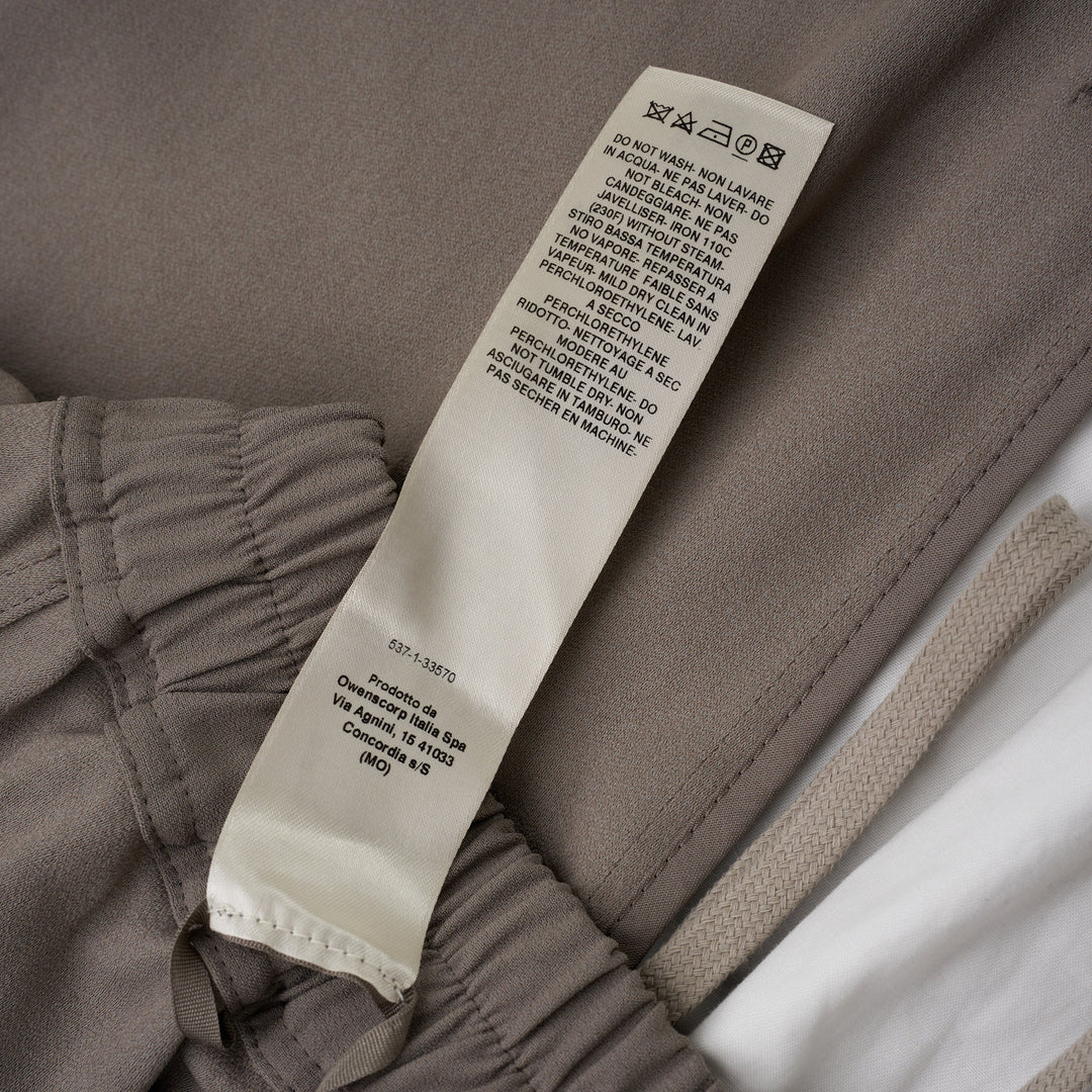 Rick Owens black boxer shorts with elasticated waistband, contrast ecru rope drawstring, and relaxed voluminous silhouette, photographed on a white background