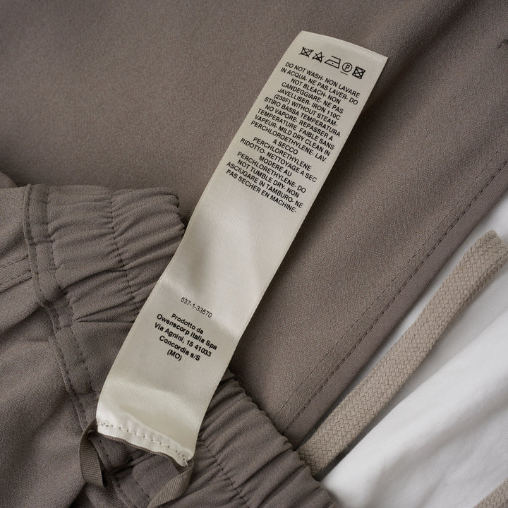 Rick Owens black boxer shorts with elasticated waistband, contrast ecru rope drawstring, and relaxed voluminous silhouette, photographed on a white background