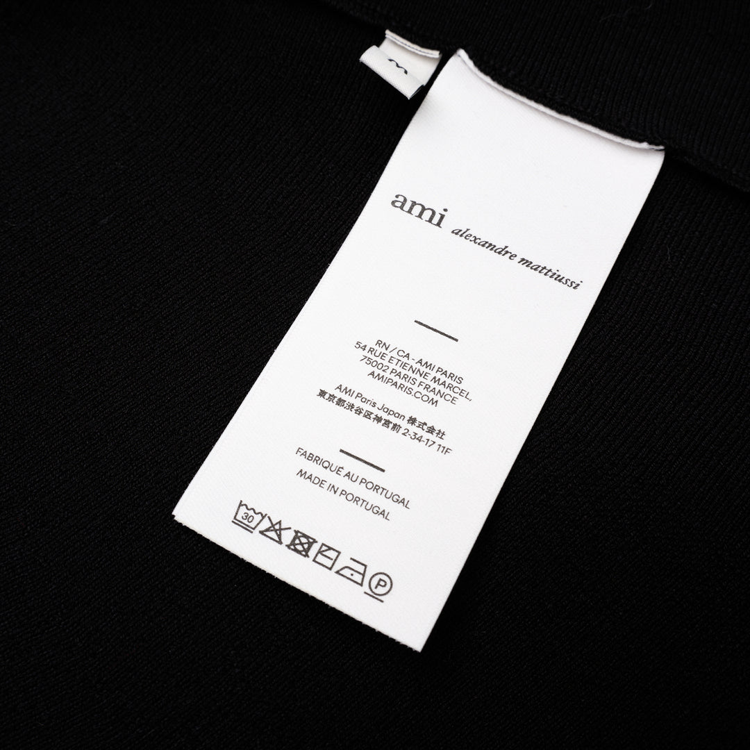 AMI Godet Short Skirt in black, featuring a full circular flared silhouette and wide ribbed waistband, displayed on a white background