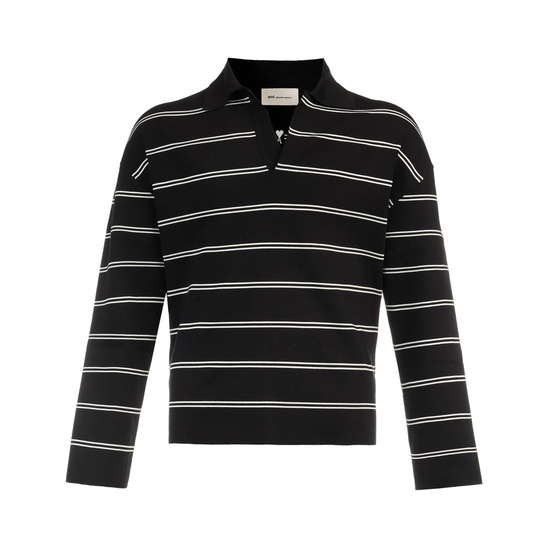 AMI Alexandre Mattiussi Long Sleeve Striped Polo in black with white horizontal stripes, featuring a spread collar, half-zip placket with heart logo pull, and ribbed cuffs