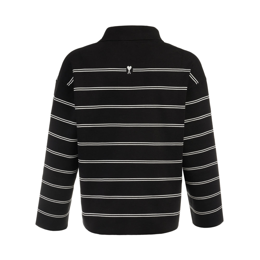 AMI Alexandre Mattiussi Long Sleeve Striped Polo in black with white horizontal stripes, featuring a spread collar, half-zip placket with heart logo pull, and ribbed cuffs - view 2
