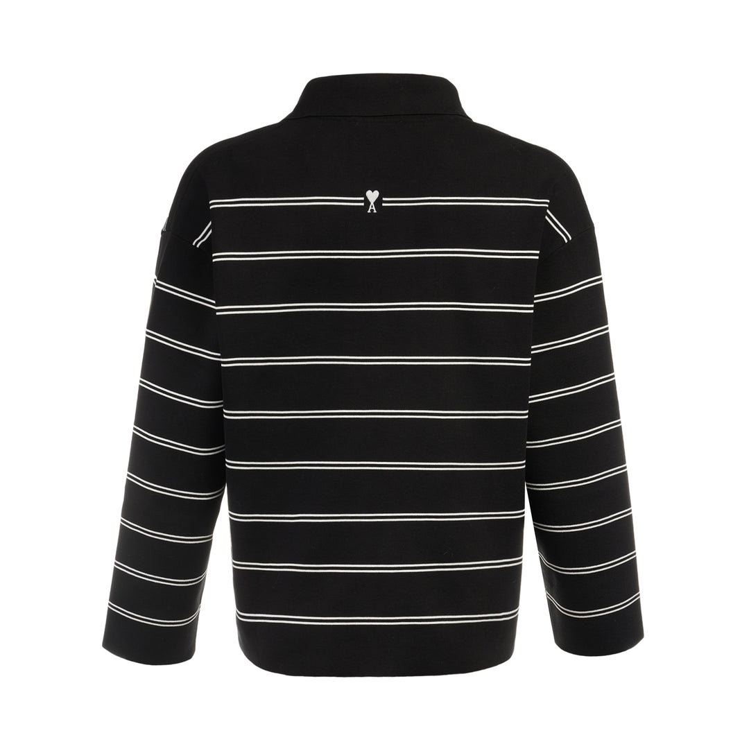 AMI Alexandre Mattiussi Long Sleeve Striped Polo in black with white horizontal stripes, featuring a spread collar, half-zip placket with heart logo pull, and ribbed cuffs - view 2