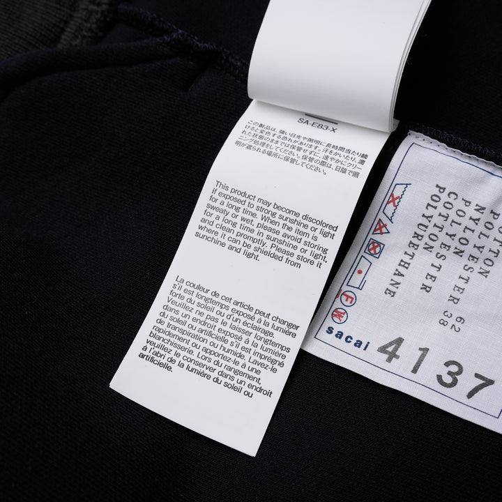 sacai Sponge Sweat Blouson in navy with asymmetric diagonal zip, contrast dark ribbed hem and cuffs, chest snap tabs and off-white sleeve zip pocket - view 8