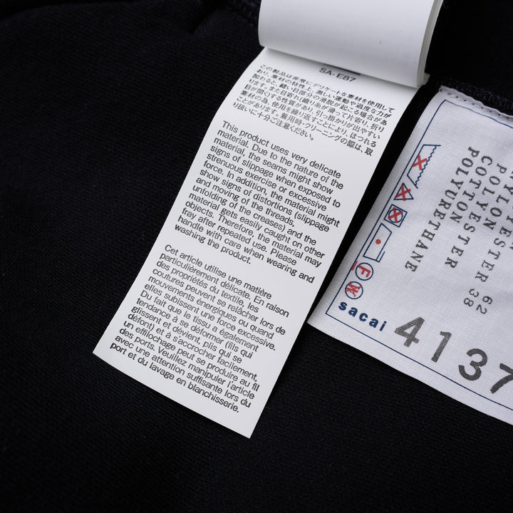 sacai Sponge Sweat Blouson in navy with asymmetric diagonal zip, contrast dark ribbed hem and cuffs, chest snap tabs and off-white sleeve zip pocket - view 9