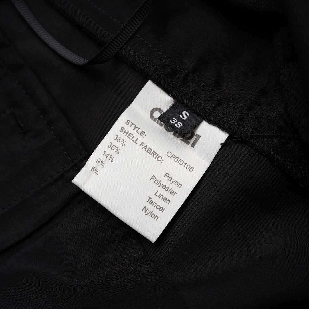 Black longline tailored shorts with a front box pleat, belt loops and concealed fly closure, shown from the front - view 3