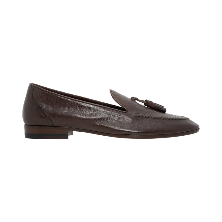 The Row Caden loafer in brown grained leather with leather tassel, moccasin stitching and low stacked heel, side view
