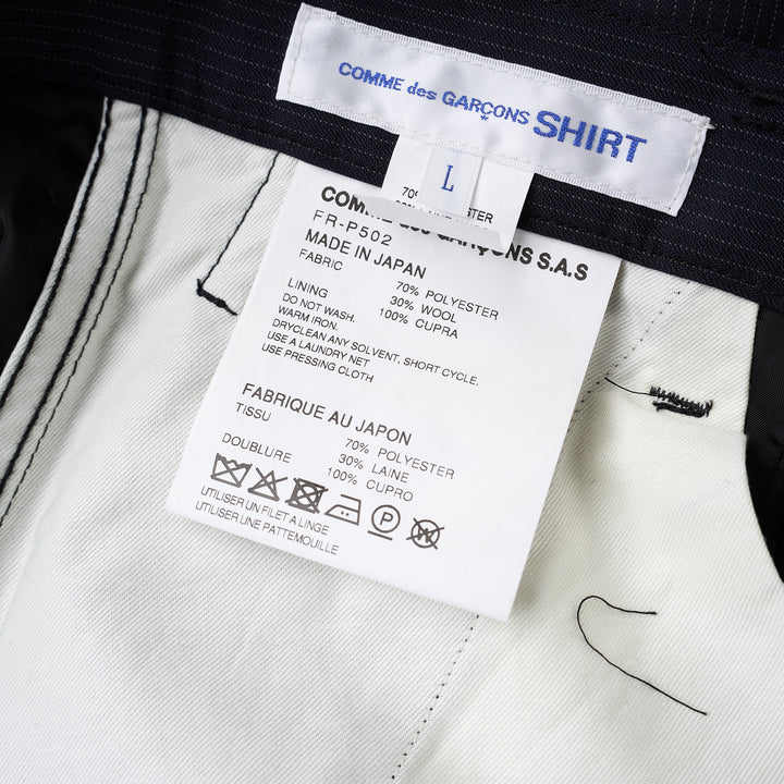 Navy pinstripe pleated cargo shorts by Comme des Garçons Shirt with a wide-leg cut, flap pockets and button fly, shown from the front - view 3