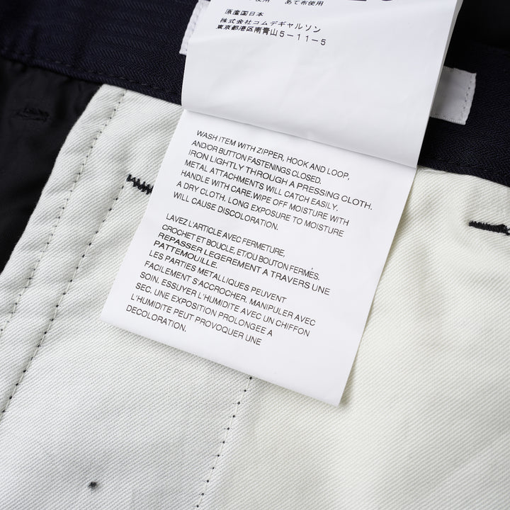 Comme des Garçons Shirt dark navy striped drop-crotch cargo pants with flap side pockets and cropped legs, shown from the front - view 4