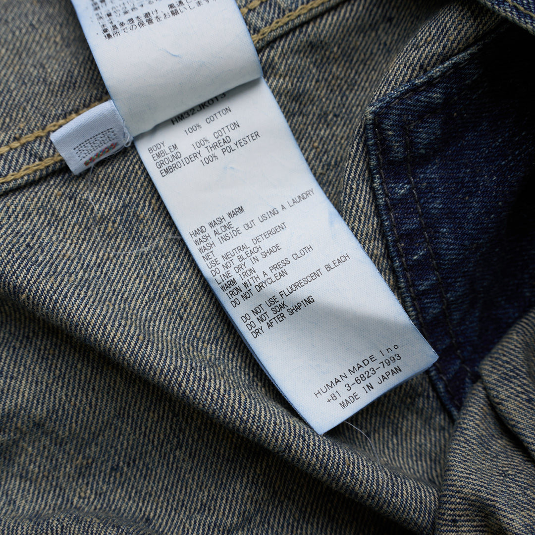 Human Made washed indigo denim work jacket with pleated front, button closure and heart-shaped logo patch on the chest - view 4