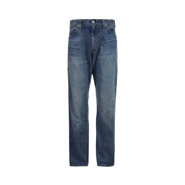 Human Made slim denim pants in a washed mid-indigo finish, shown front-facing with button fly and contrast topstitching