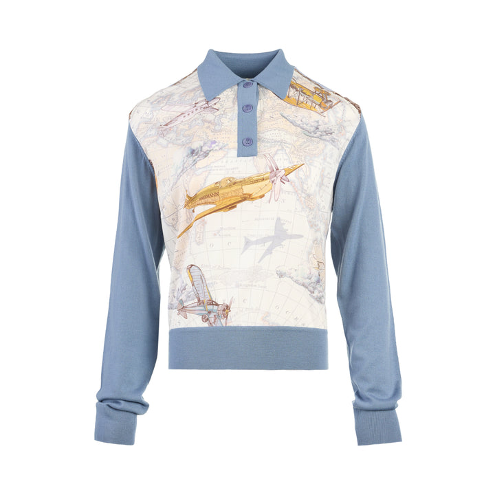 Zimmermann Valiant long sleeve polo with a silk front panel printed with a vintage world map and aeroplanes, framed by blue knit collar, sleeves, and hem