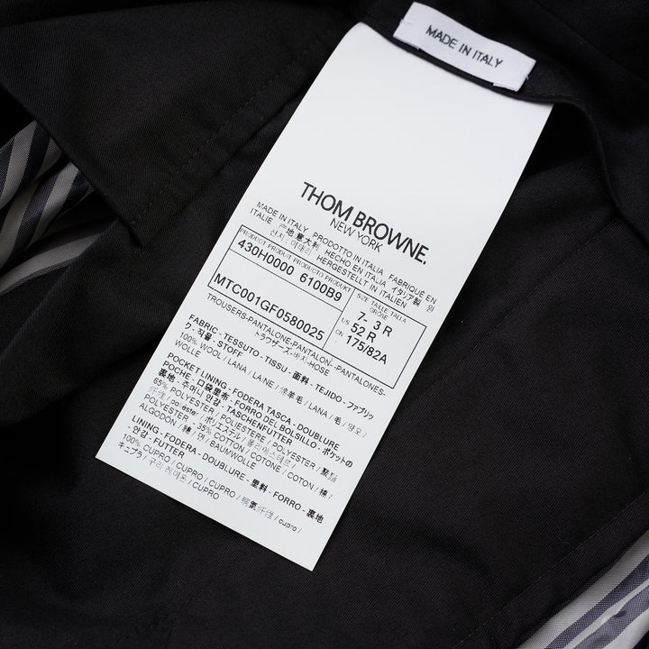 Thom Browne Fit 1 backstrap trousers in charcoal grey with flat front and slim straight leg, shown front view - view 3