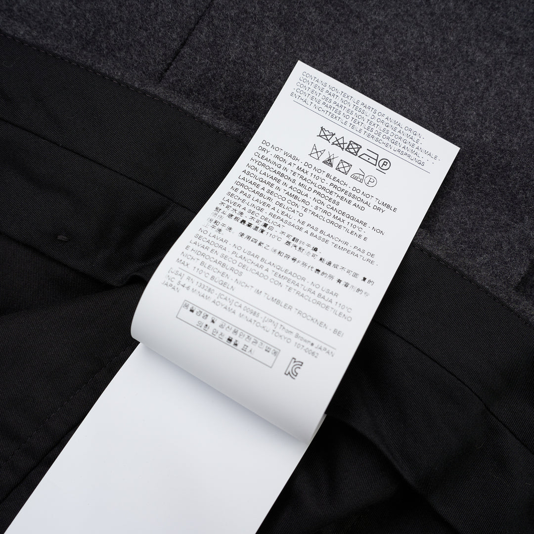 Thom Browne Fit 1 backstrap trousers in charcoal grey with flat front and slim straight leg, shown front view - view 4