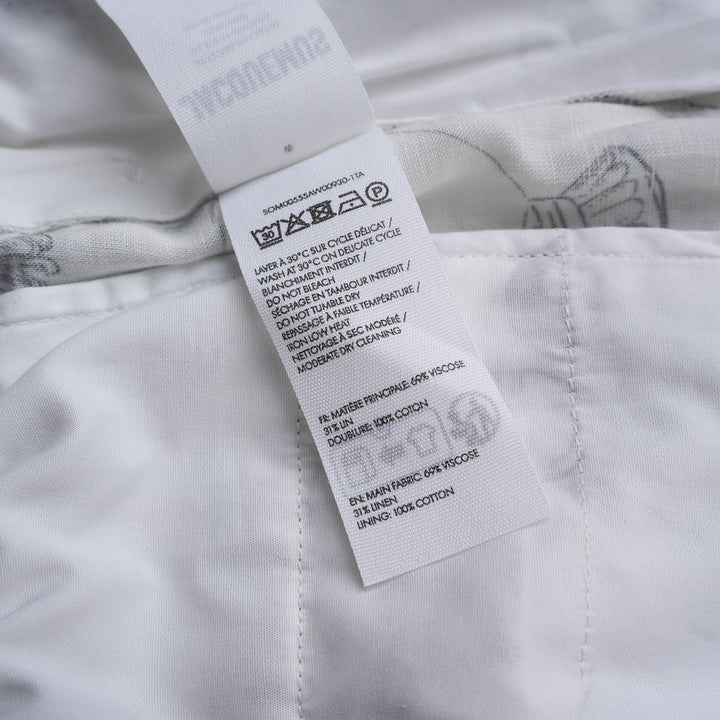 Jacquemus Le Boxer shorts in white with a black and grey illustrated print of shells, fish, grapes and champagne coupes, shown with a smocked high waistband - view 3