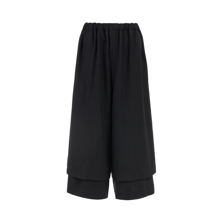 Comme des Garçons black wool georgette wide-leg pants with an elasticated waist and double-layered hem, shown from the front
