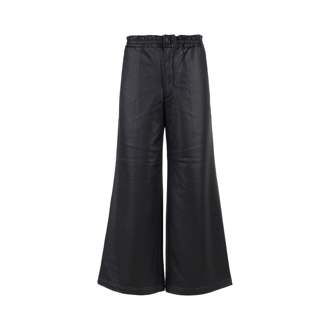Comme des Garçons Homme Plus black gloss finish wide-leg flared pants with elasticated waistband, shown from the front