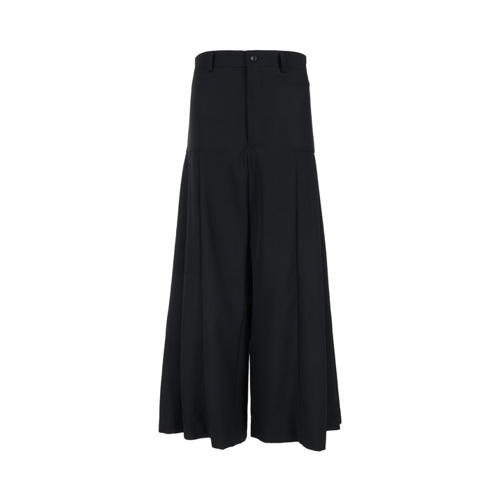 Black wool gabardine wide-leg pants with pleated skirt-like panels and high waist by Comme des Garçons Comme des Garçons