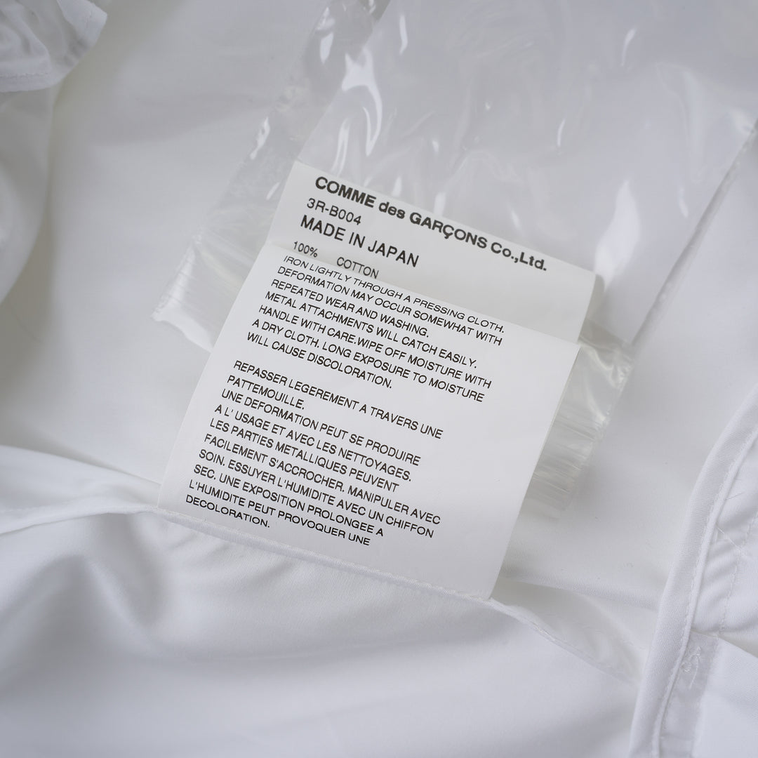 Noir Kei Ninomiya white cotton typewriter shirt with tiered pleated ruffle sleeves, pointed collar, button placket and curved flared hem - view 4