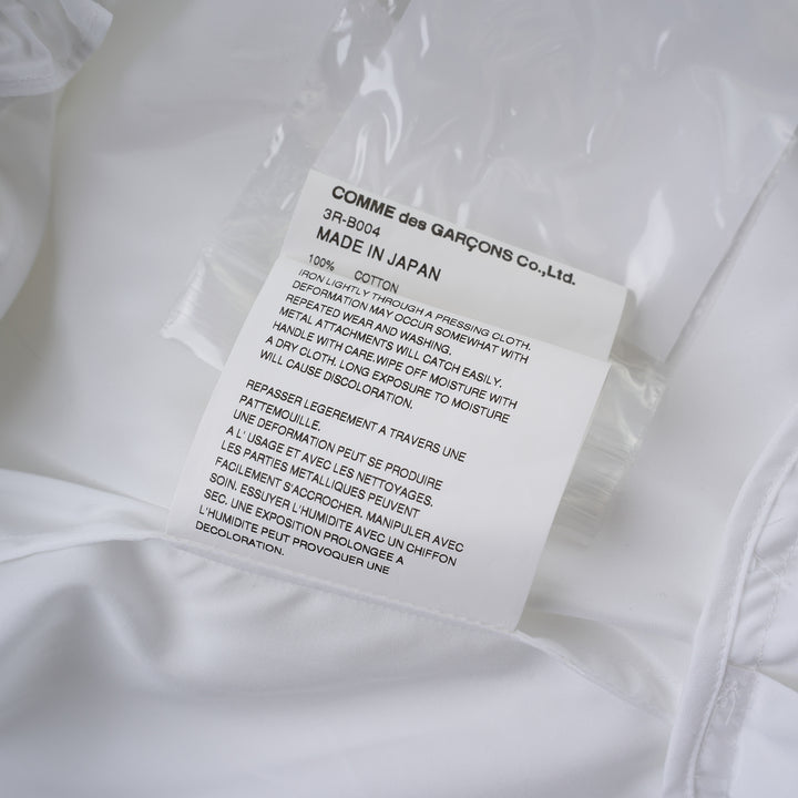 Noir Kei Ninomiya white cotton typewriter shirt with tiered pleated ruffle sleeves, pointed collar, button placket and curved flared hem - view 4