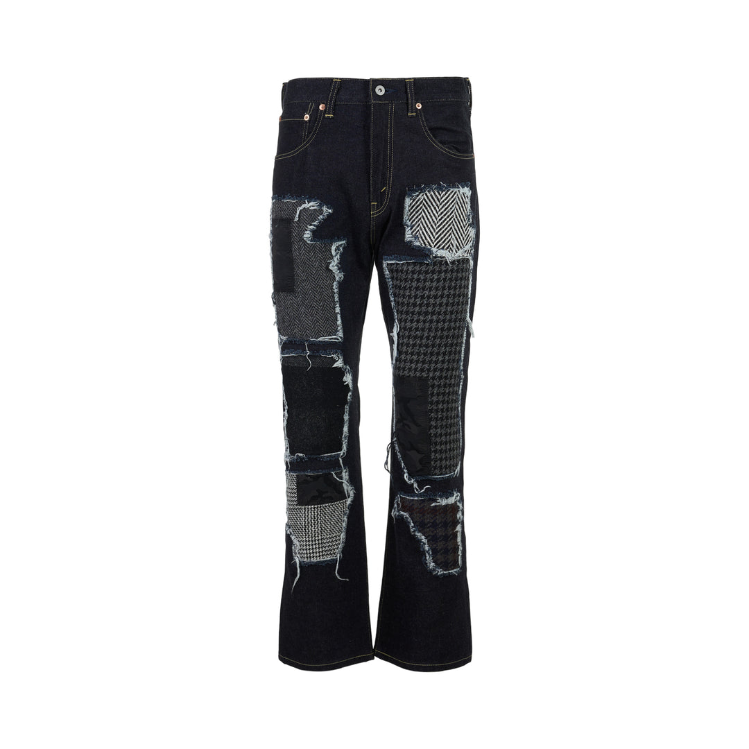 Junya Watanabe dark indigo straight-leg jeans with frayed herringbone, houndstooth and camouflage patchwork panels, front view
