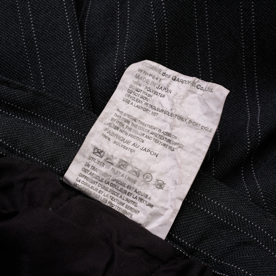 Junya Watanabe charcoal pinstripe wide-leg pants with front pleat and button closure, shown from the front - view 3