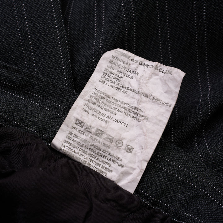 Junya Watanabe charcoal pinstripe wide-leg pants with front pleat and button closure, shown from the front - view 3