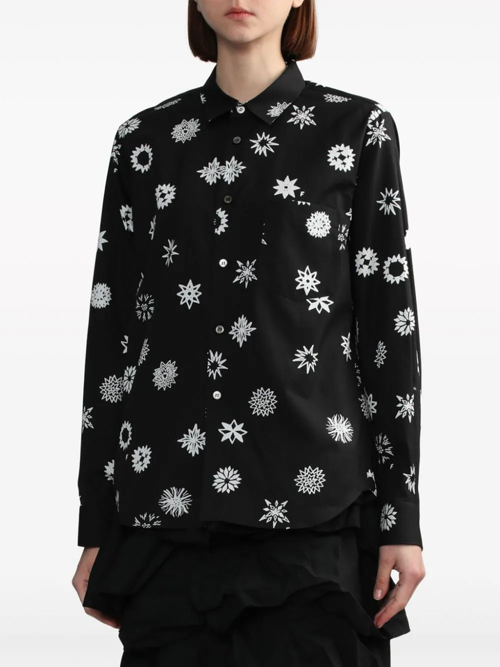 Comme des Garçons BLACK Filip Pagowski Print Blouse in black with allover white snowflake and floral graphic motifs, long sleeves and point collar, flat lay view