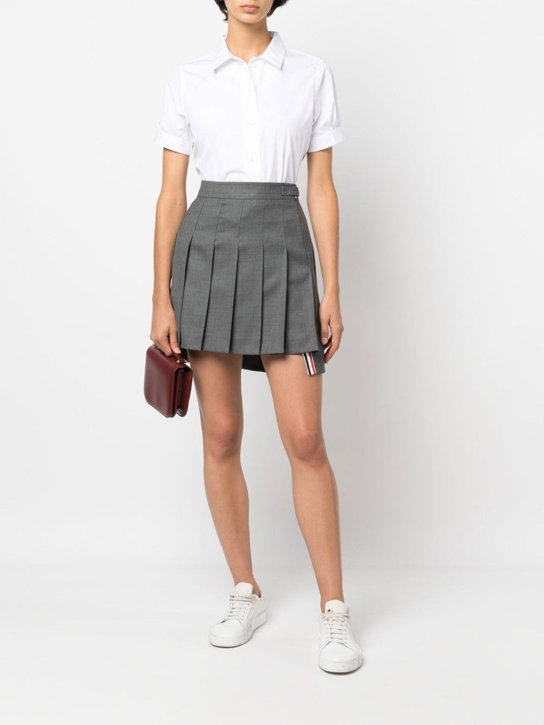 Thom Browne white cropped short sleeve button-front shirt with point collar and cuffed sleeves on a plain white background