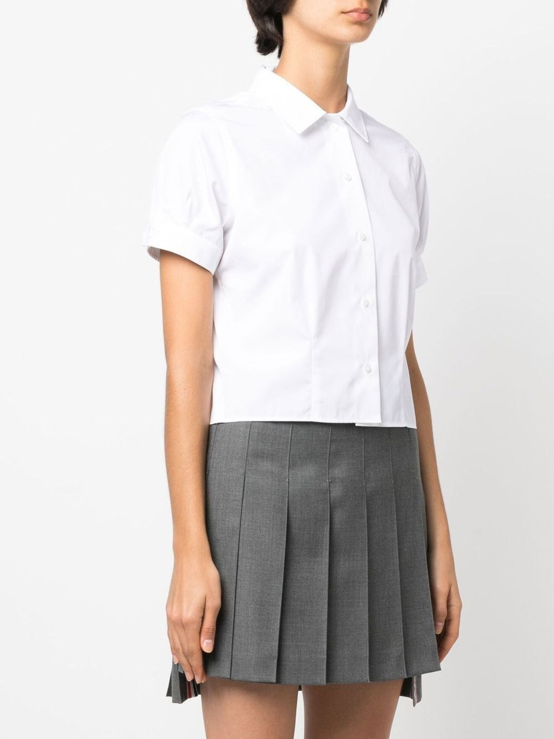 Thom Browne white cropped short sleeve button-front shirt with point collar and cuffed sleeves on a plain white background