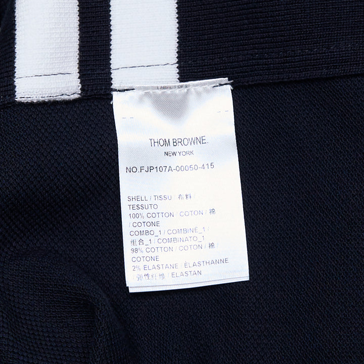Thom Browne Short Sleeve Rib Cuff Polo in light blue piqué cotton with spread collar, four-button placket and signature stripe grosgrain tab