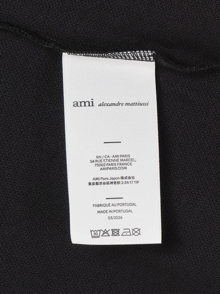 Ami Alexandre Mattiussi black piqué polo shirt with white Ami de Cœur logo embroidery on the chest and a two-button placket, front view - view 4
