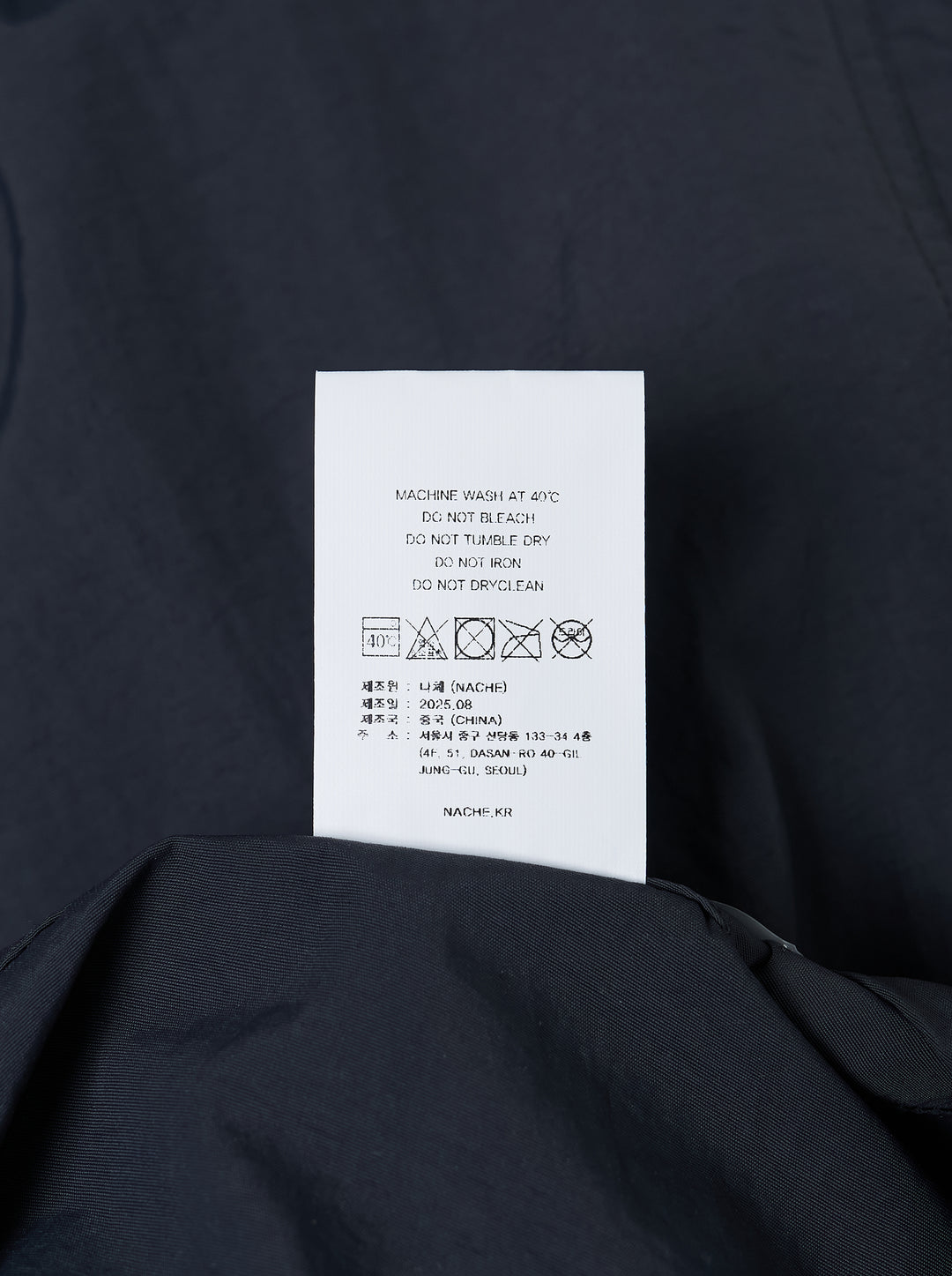 Dark navy wide-leg Nache nylon pants with a drawstring waist and ruched, pintucked hems, shown from the front - view 3