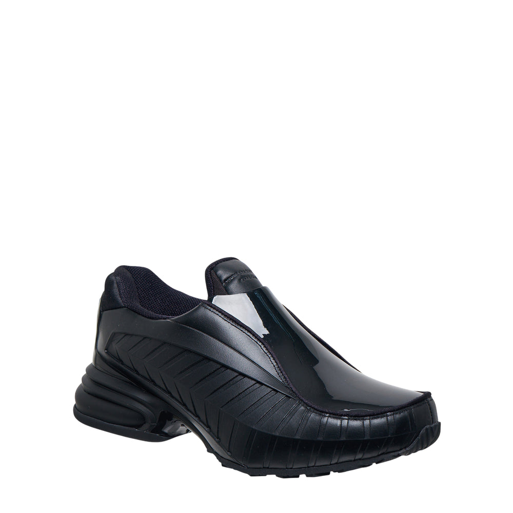 Comme des Garçons Homme Plus x Nike Air Max Dolce SP CDG all-black leather slip-on sneaker with ribbed panelling and chunky sole, lateral view