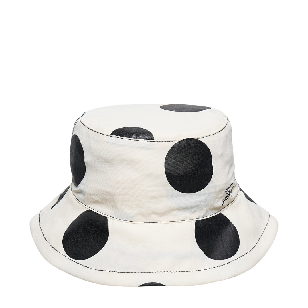 Jacquemus Le Bob Baluchon bucket hat in off-white with large black polka dots, featuring a wide brim with contrast topstitching and script logo detail