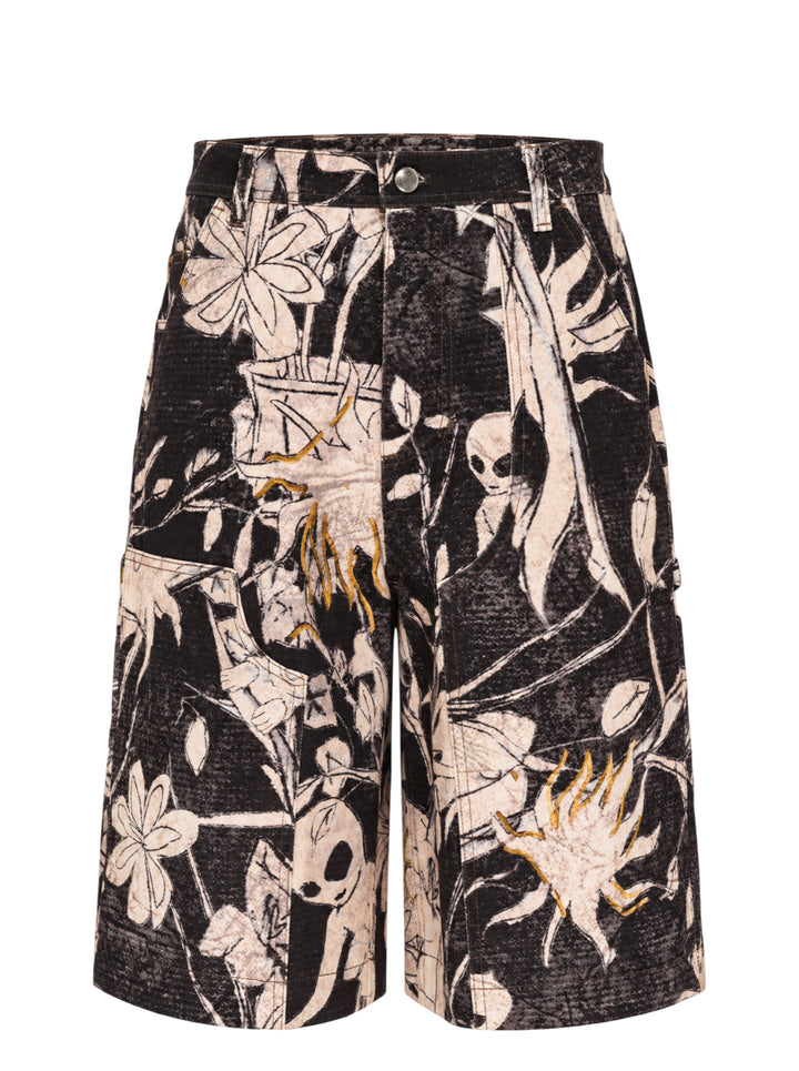 Andersson Bell carpenter shorts with an all-over black and cream floral and alien print, gold embroidered accents, and utility pocket detailing