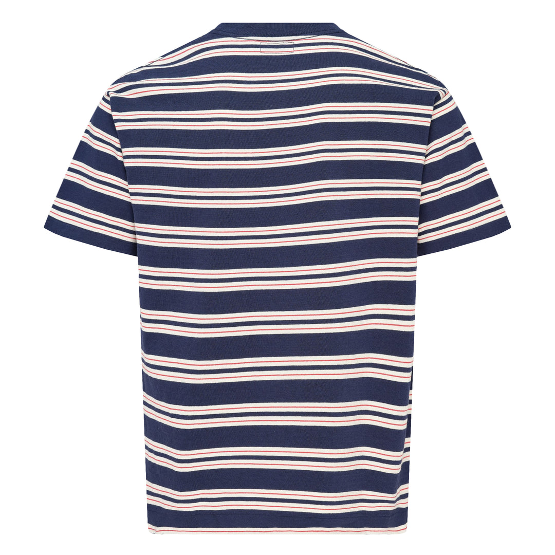 Human Made Striped Short Sleeve Tee in sky blue with horizontal multicolour stripes in cream, yellow, and blush, featuring an embroidered yellow heart logo patch at the chest