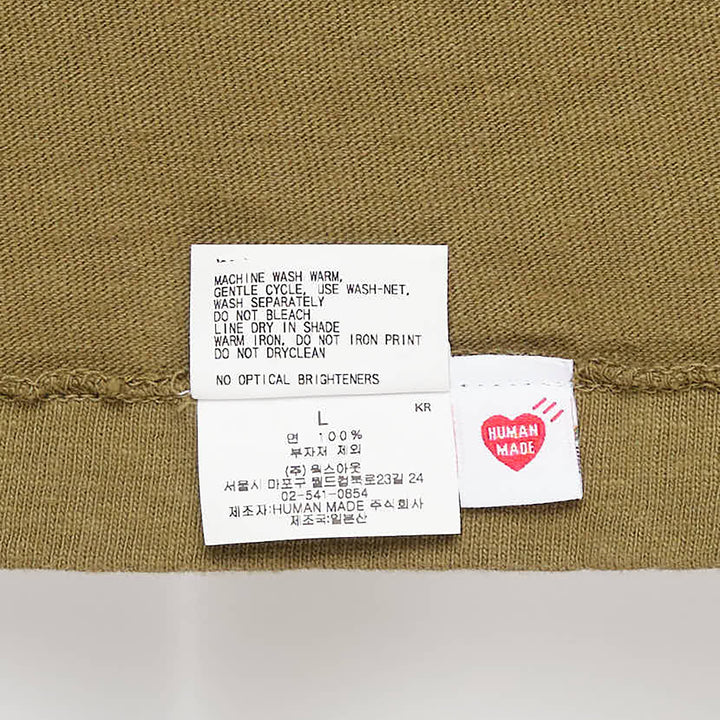 Human Made Color Heart Logo Tee in dusty blue, featuring a white cursive 'Human Made' heart graphic print at the chest, crew neck, and short sleeves