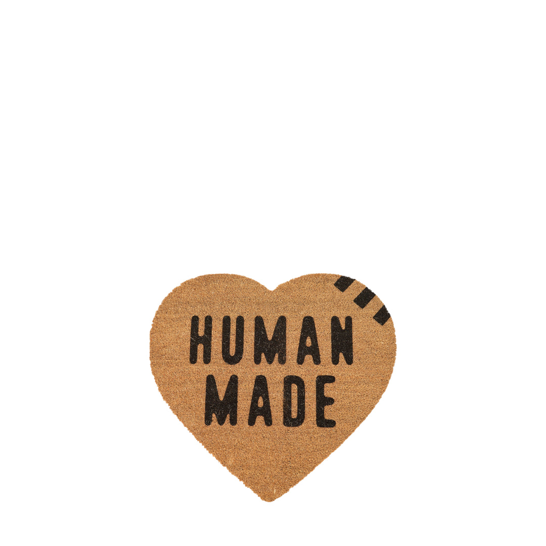 Human Made large heart-shaped coir rug with bold black 'Human Made' typographic print on a natural tan fibre surface