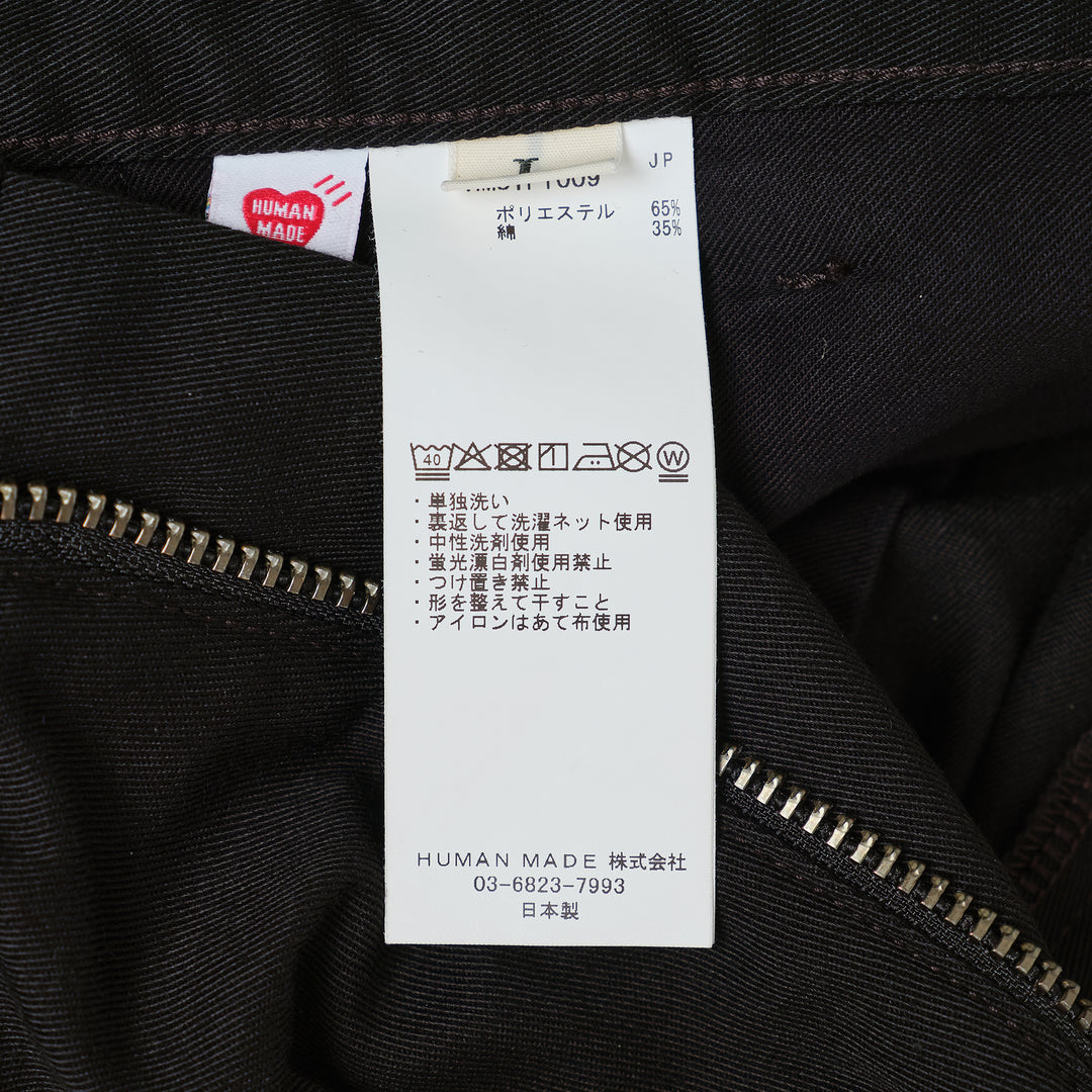 Human Made Skater Shorts in black with embroidered heart-and-arrow logo near the hem and yellow woven brand label at the waistband
