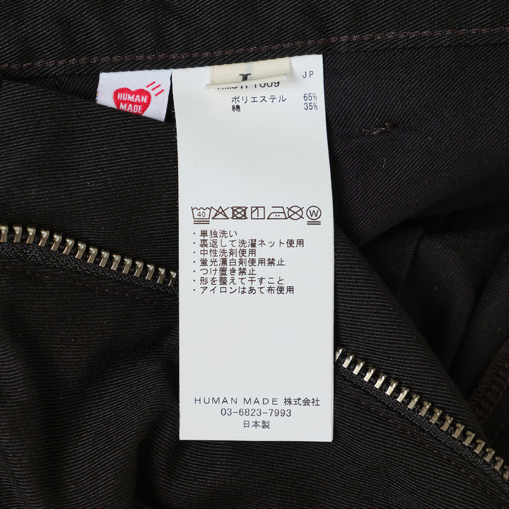 Human Made Skater Shorts in black with embroidered heart-and-arrow logo near the hem and yellow woven brand label at the waistband