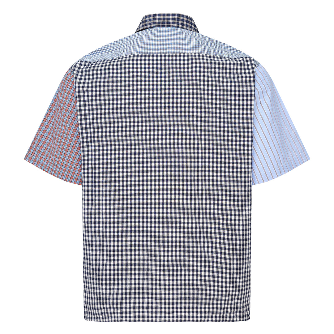 Human Made Crazy Check Short Sleeve Shirt featuring patchwork multi-check and plaid panels in green, yellow, blue, and navy, with contrast chest pockets and an embroidered heart logo patch