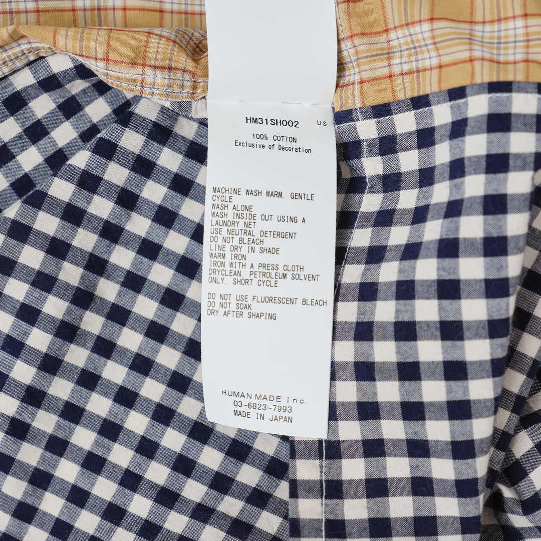Human Made Crazy Check Short Sleeve Shirt featuring patchwork multi-check and plaid panels in green, yellow, blue, and navy, with contrast chest pockets and an embroidered heart logo patch