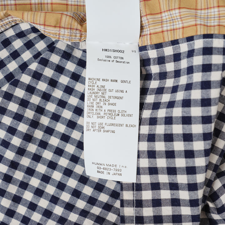 Human Made Crazy Check Short Sleeve Shirt featuring patchwork multi-check and plaid panels in green, yellow, blue, and navy, with contrast chest pockets and an embroidered heart logo patch