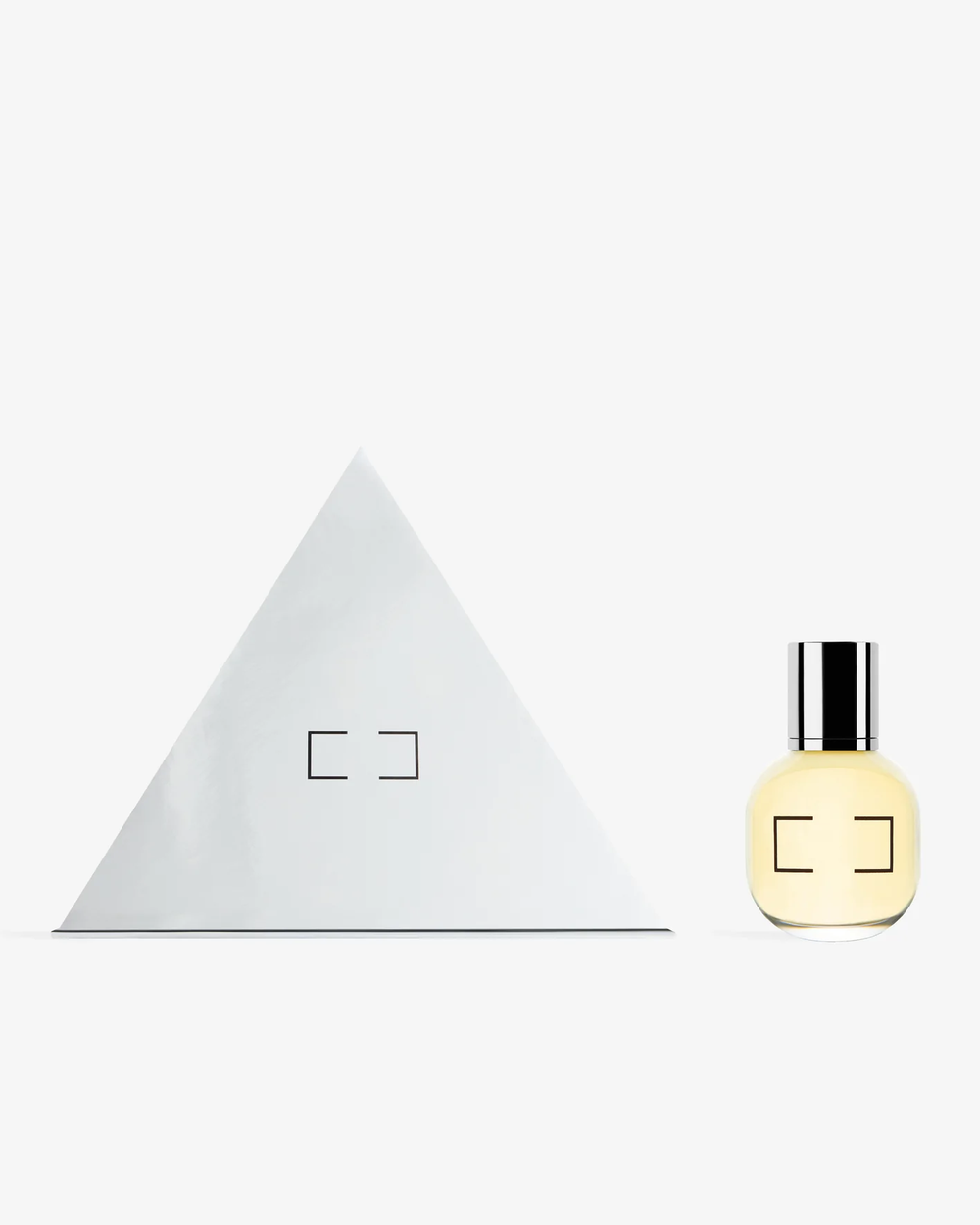 Comme des Garçons Parfums Dia x Meg Webster Eau de Toilette 50ml spray bottle — pale yellow rounded glass with silver cap and bracket logo