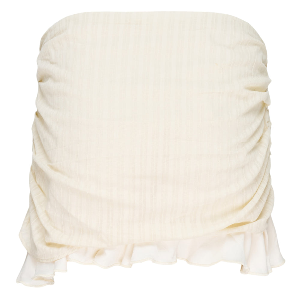 Glowny Misty Sheer Mini Skirt in cream with ruched draping, vertical grommet strap, and ruffled hem on a white background
