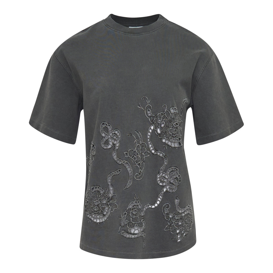 Ganni Heavy Cotton Embroidery Tee in washed charcoal grey, featuring tonal floral cutwork lace embroidery across the front, with a relaxed boxy fit and ribbed crew neckline