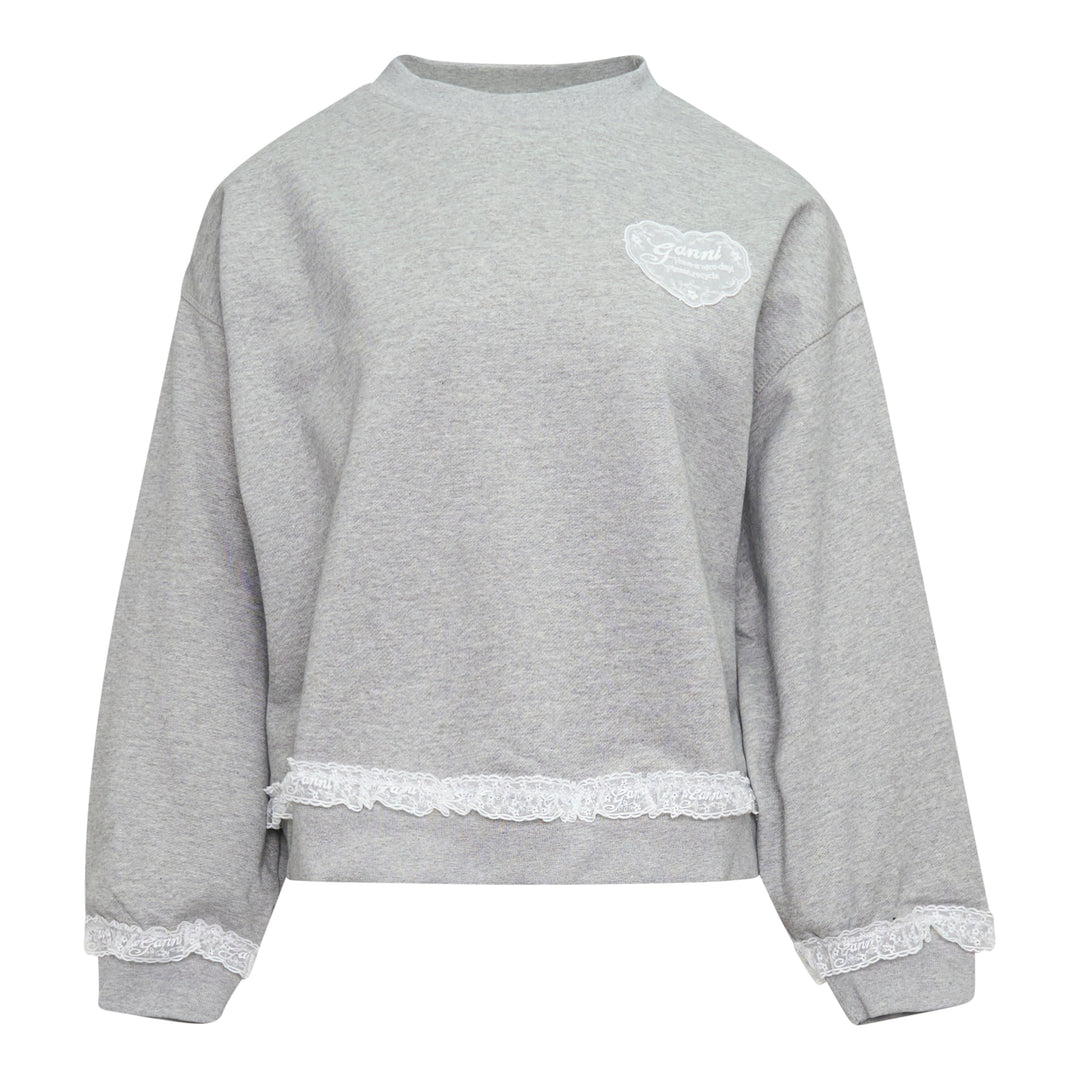 Ganni Isoli Sweater in heather grey marl with white lace frill trim at the hem and cuffs, and an embroidered heart-shaped Ganni logo patch on the chest