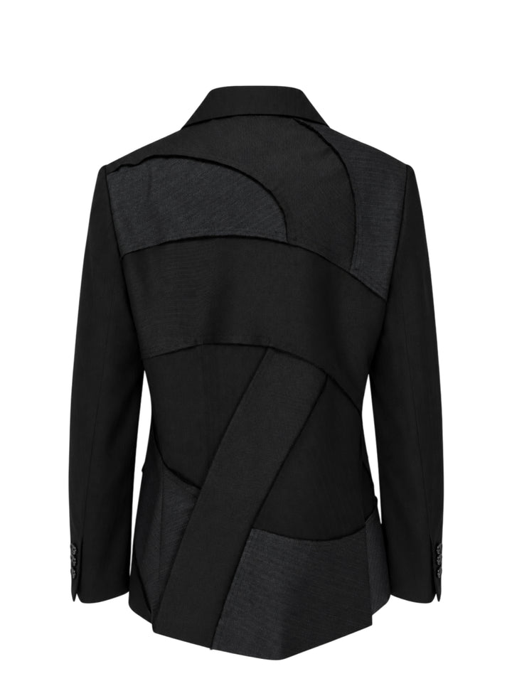 Black single-breasted herringbone tailored jacket with curved patchwork panel inserts, notch lapel and flap pockets by Comme des Garçons Black - view 2