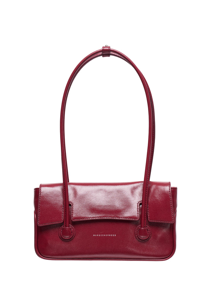 Marge Sherwood Flap Small shoulder bag in deep crimson glossy leather with elongated shoulder strap and dual ring loop hardware